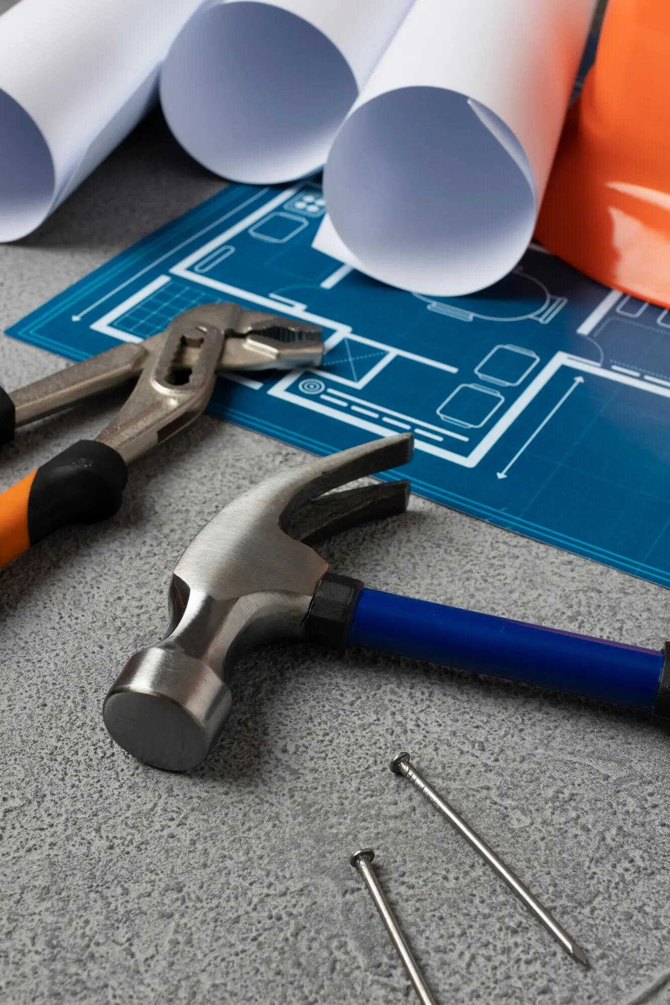 A view of a steel hammer among other construction elements and tools.
